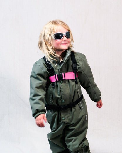 A kid wearing a ski harness